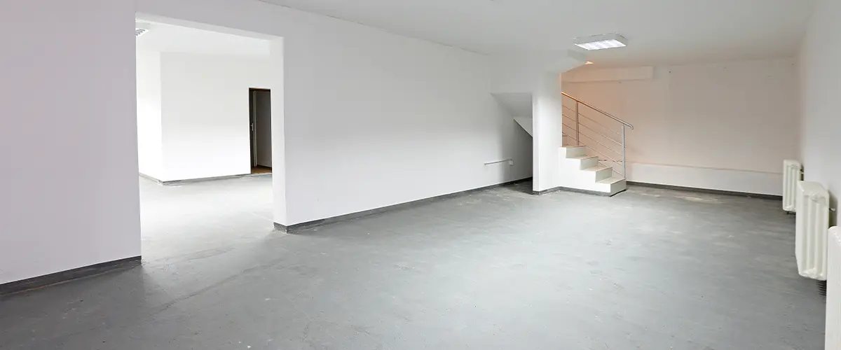 Unfinished Basement Ready for Renovation - Open-concept unfinished basement with concrete flooring and modern lighting.